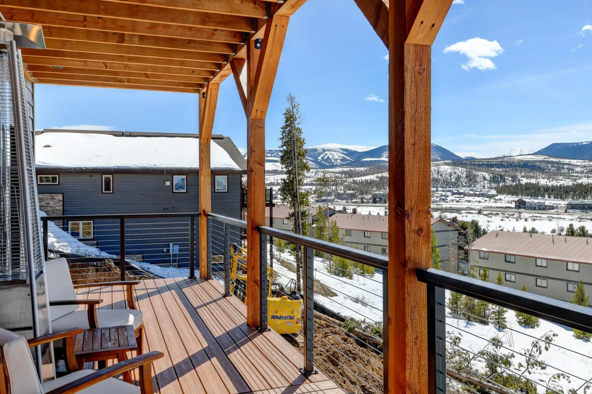 The exterior deck features a stylish wooden pergola, comfortable outdoor seating, and unobstructed mountain vistas. The setup is ideal for open-air relaxation, outdoor dinners, or enjoying sunrise and starry nights with friends and family.